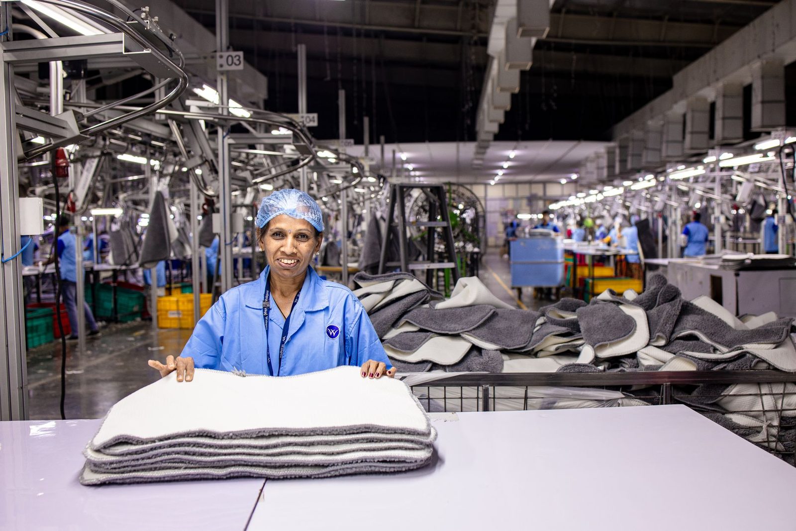 A worker at a table on a textile floor