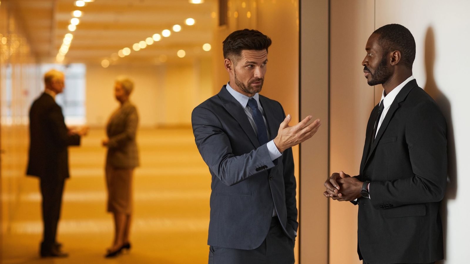 Two colleagues talking in a corridor
